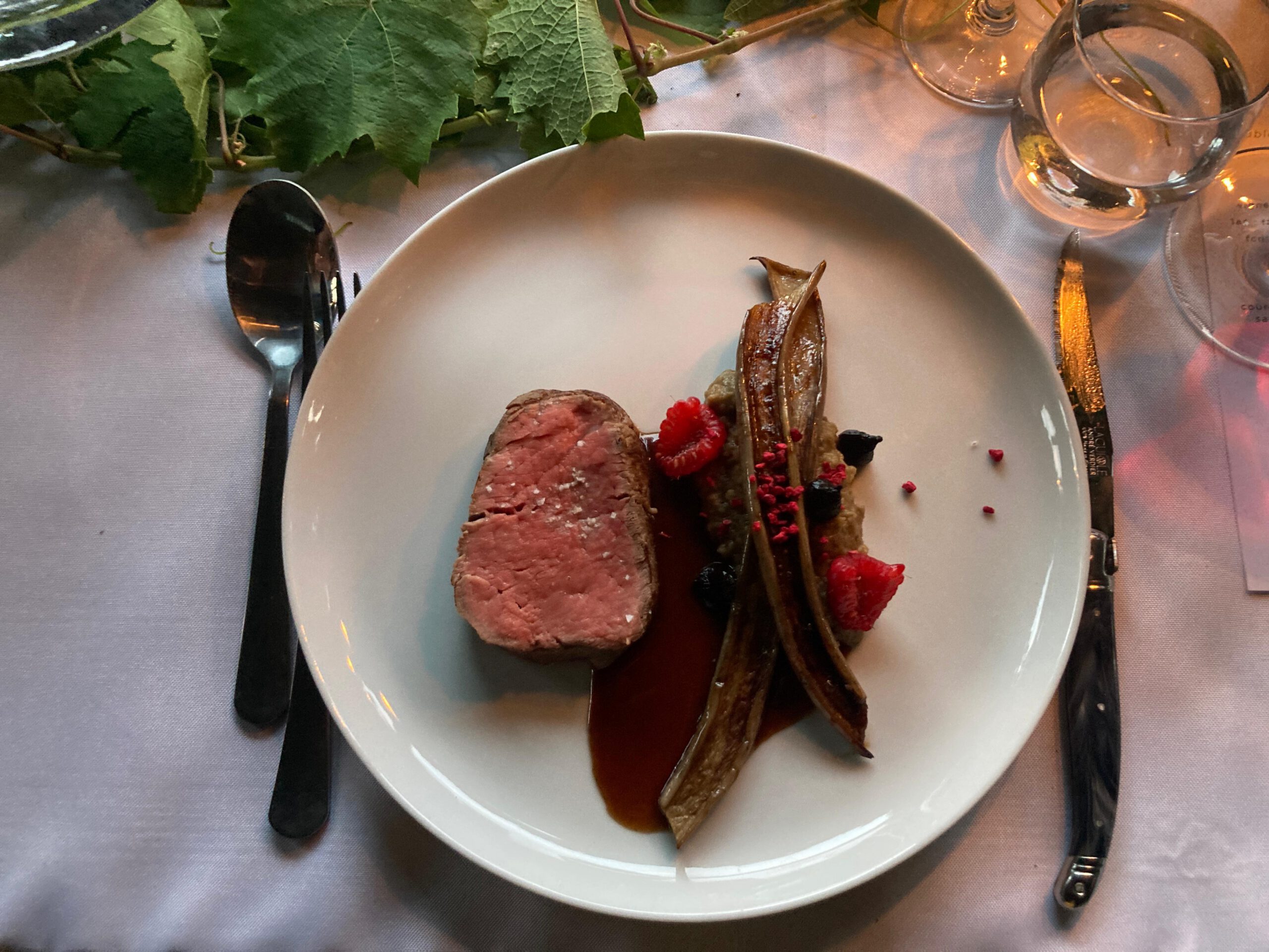 Filet de bœuf suisse -
caviar d’aubergine -
aubergine violette laquée à la raisinée -
condiment ail noir -
framboises fraîches et en éclats -
sauce bœuf et vin rouge